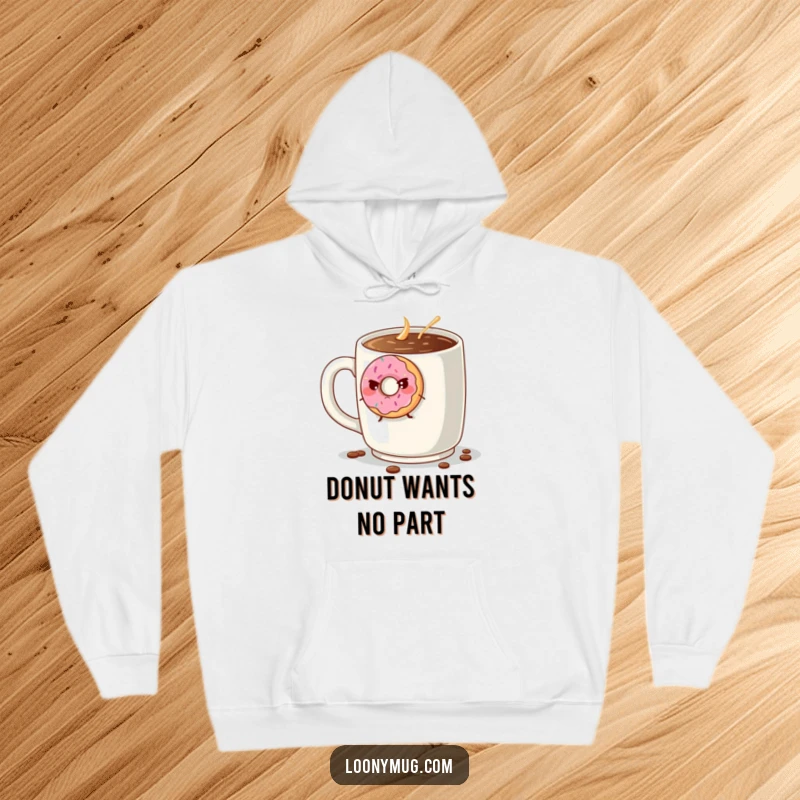 Funny grumpy donut trying to escape a giant coffee mug, on a warm and soft hoodie. A humorous apparel choice for donut enthusiasts.