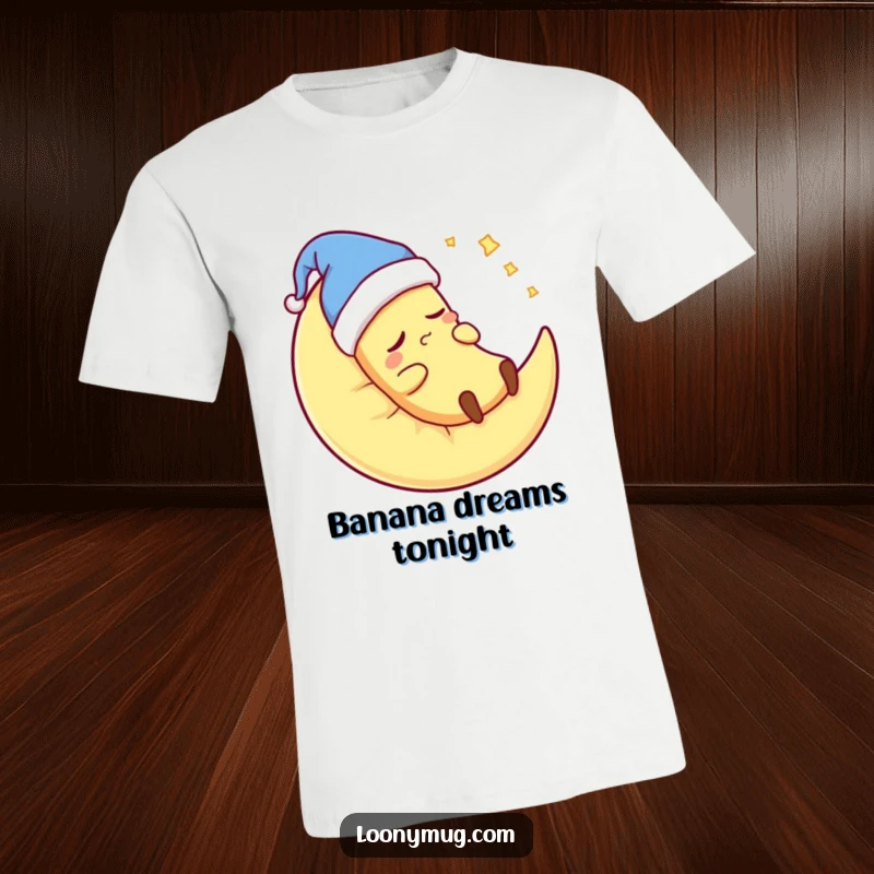 Funny banana wearing a nightcap, snoring loudly on a moon pillow, wearing a t-shirt, promoting sleep and humor.