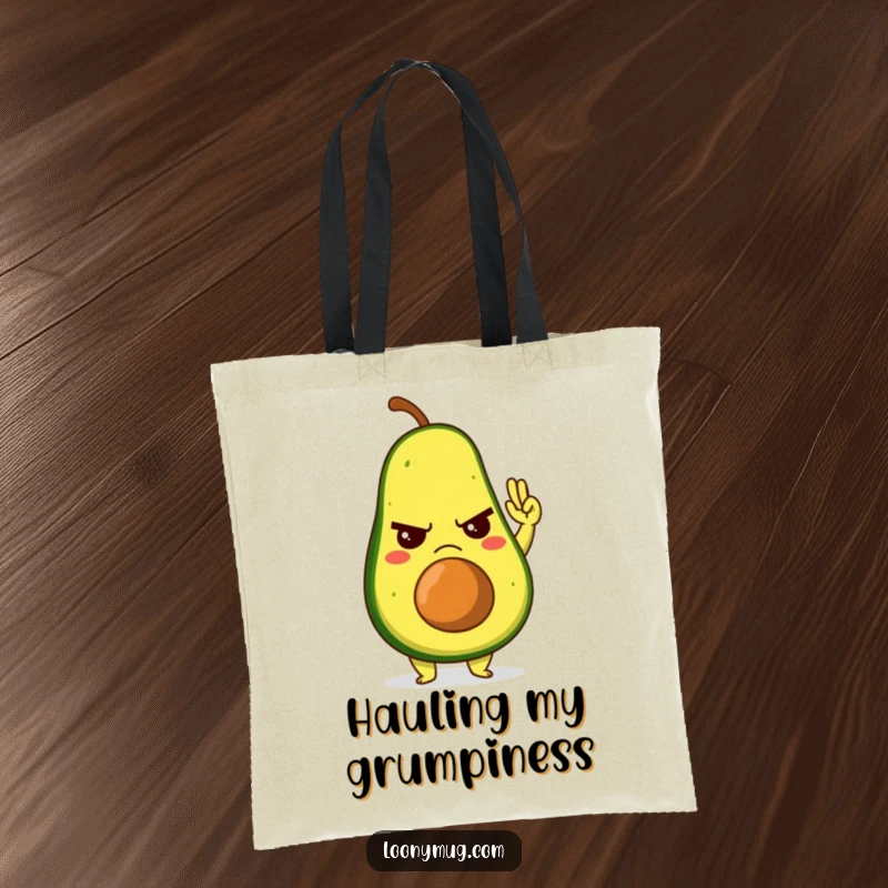 Funny tote bag showcasing a grumpy avocado character giving a reluctant high-five, ideal for carrying your mood.
