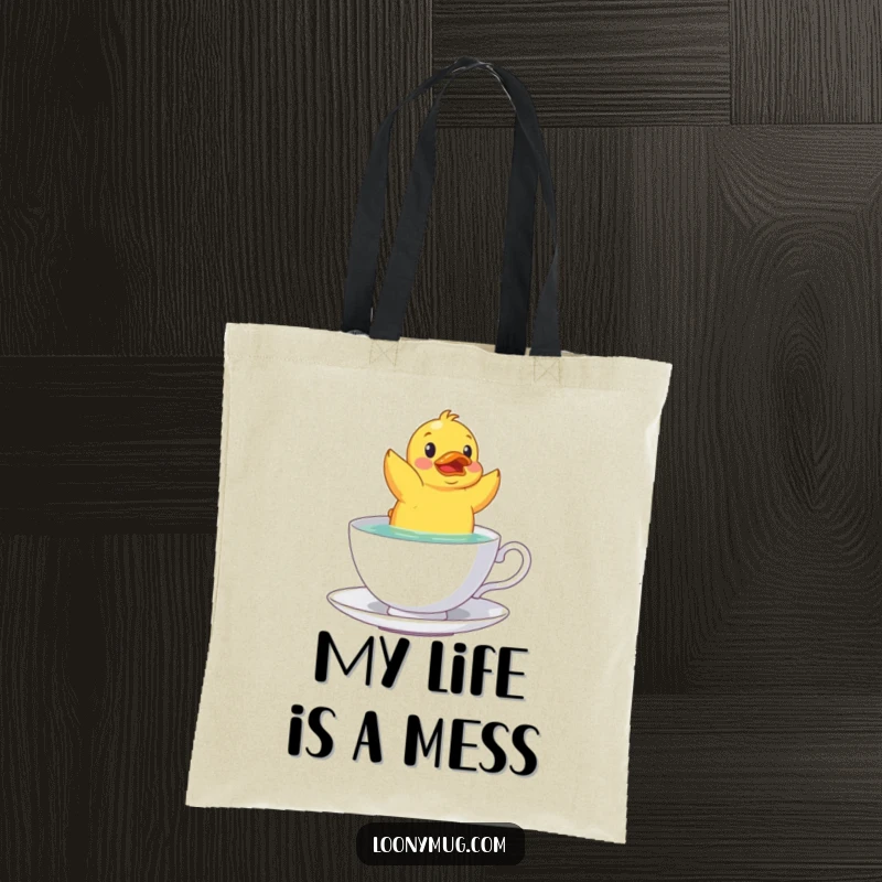 Funny rubber duck upside down in a teacup on a durable tote bag, ideal for carrying daily items.